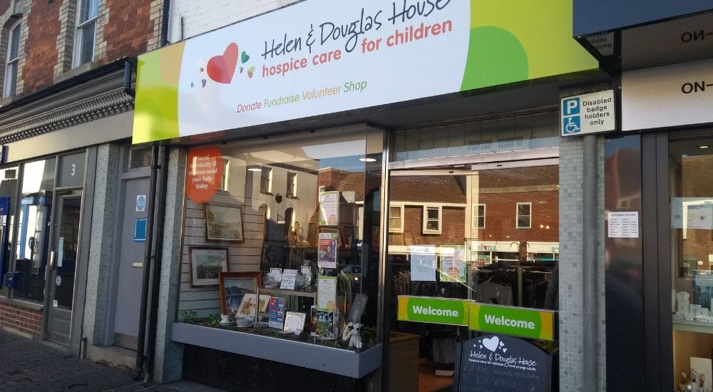 Wantage shop window with Helen & Douglas House logo 1000×500 Wantage shop window with Helen & Douglas House logo