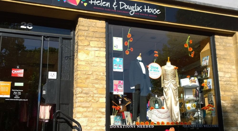 Witney (2) Witney shop window from front with dress and suit_1000x550
