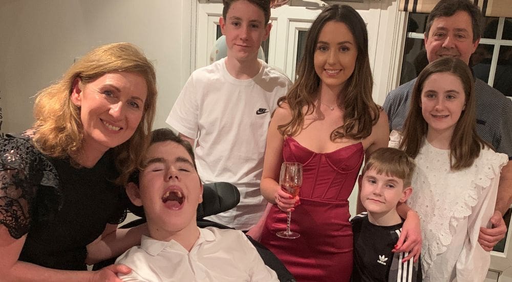Patrick with his family smiling1000x550 Patrick with his family smiling