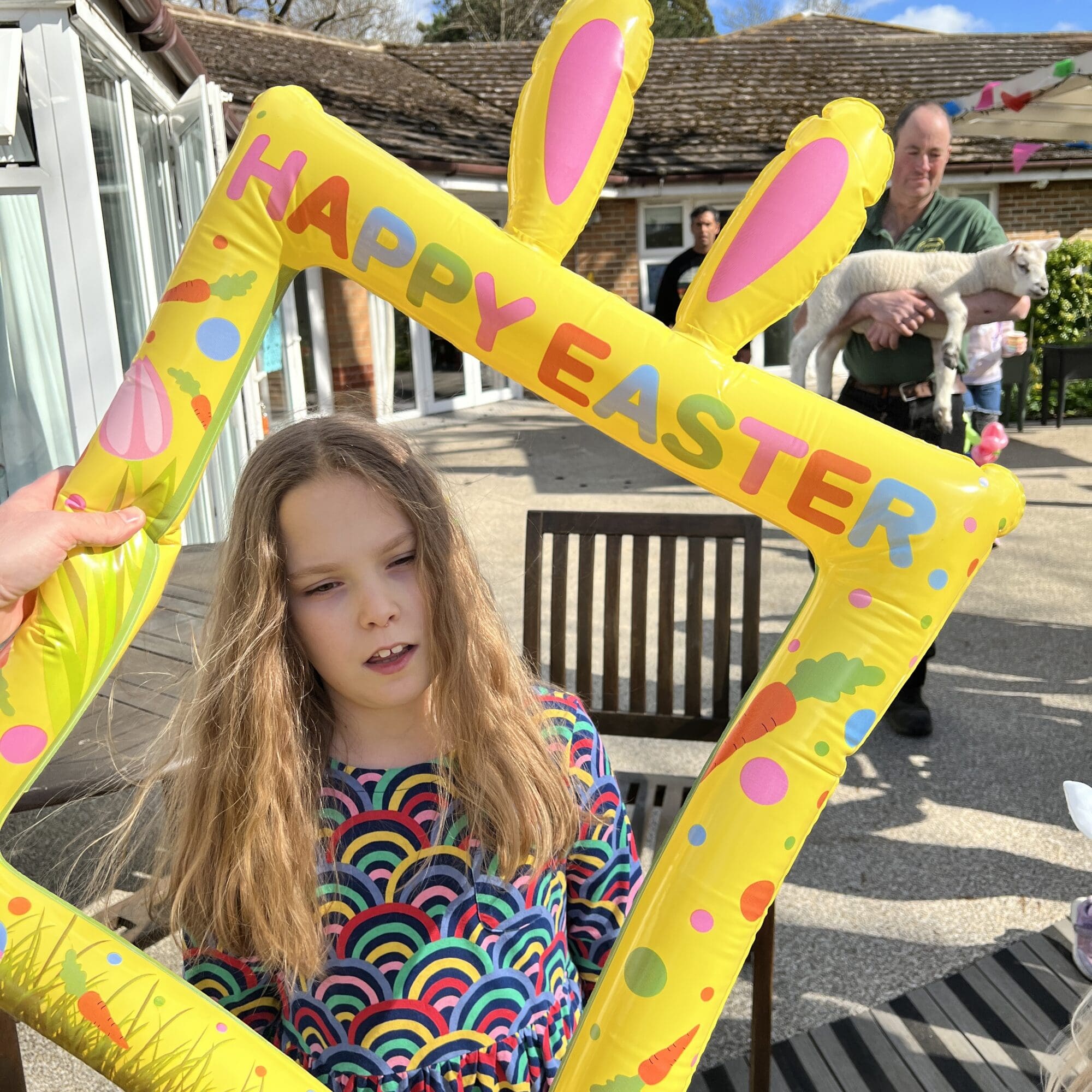 a girl holding an easter frame and smiling