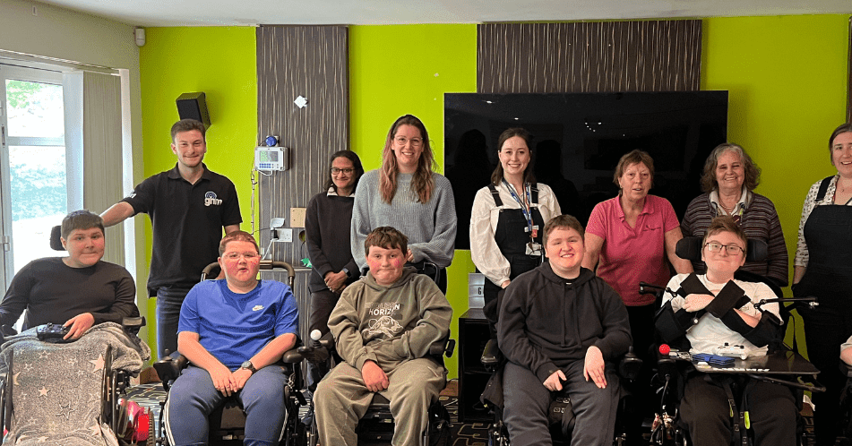 A group of teens and adults smiling at the camera