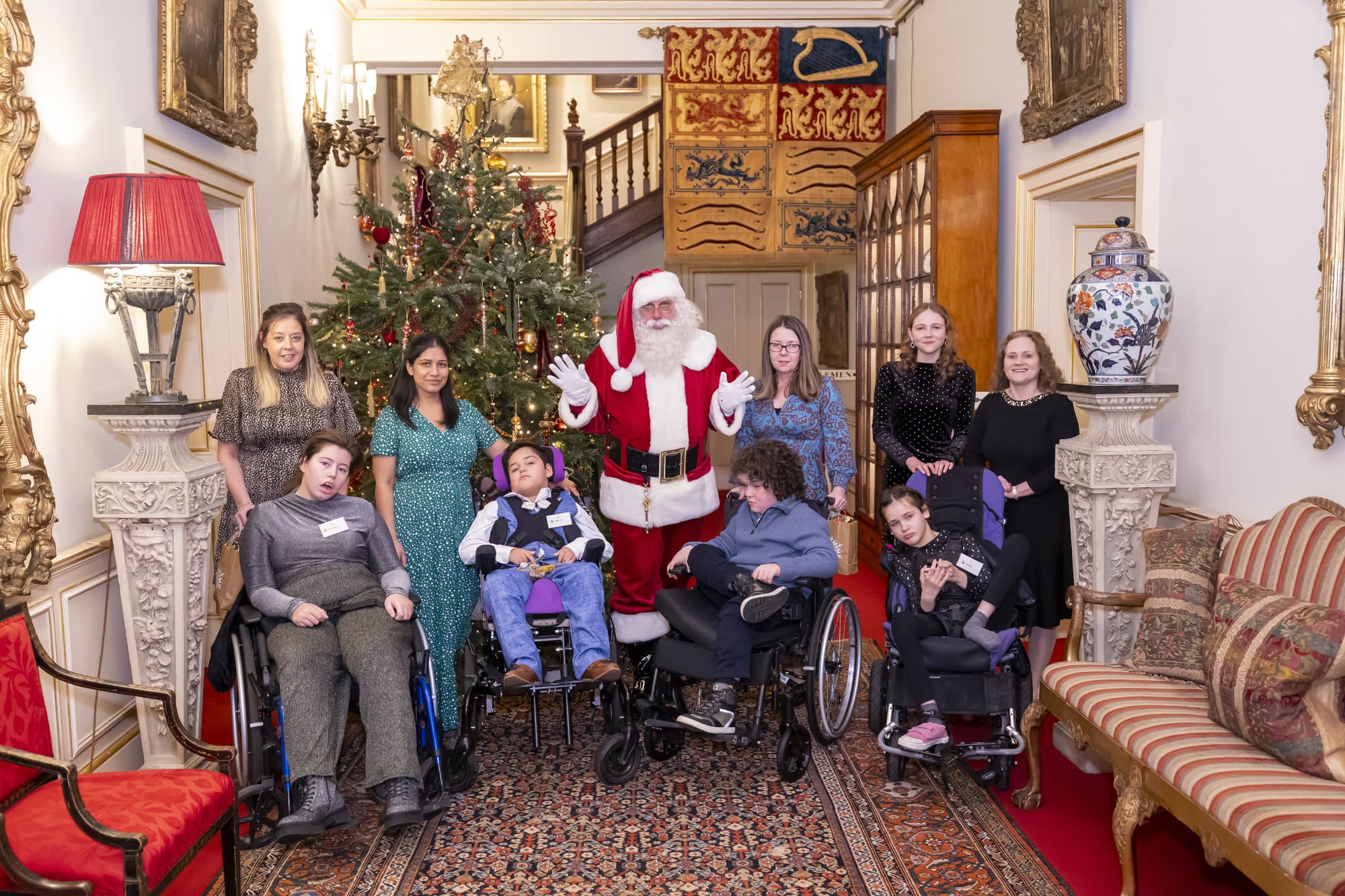Families stood with Santa by the tree at Clarence House