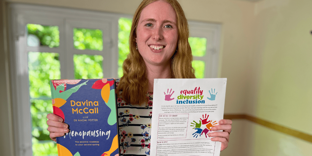 Sophie HR holding up book and smiling