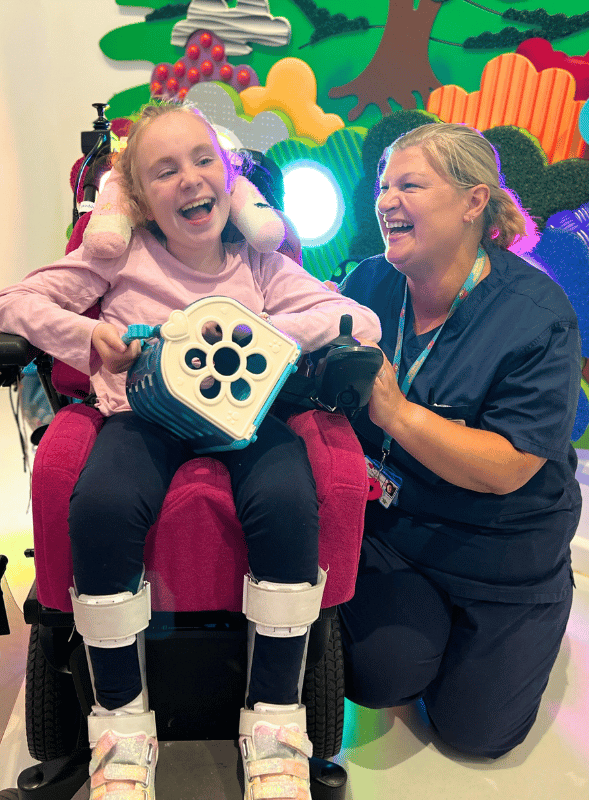 Roof Appeal Edith A girl in a wheelchair and a female nurse smiling together